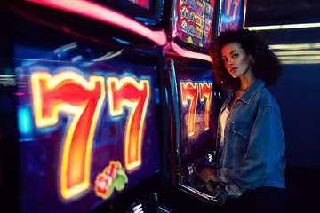 A cheerful woman in traditional clothing using her smartphone during a festive moment, showing how easily the BAA99 app fits into everyday life.